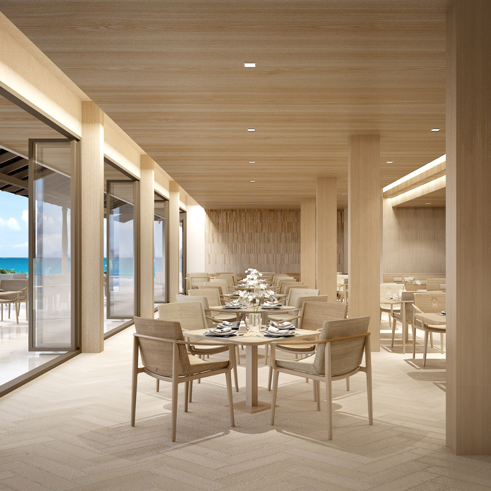 Beachfront wellness resort designed by Openbox Architects featuring a bright open lobby with ocean views, natural light through glass roof, and warm coastal materials.