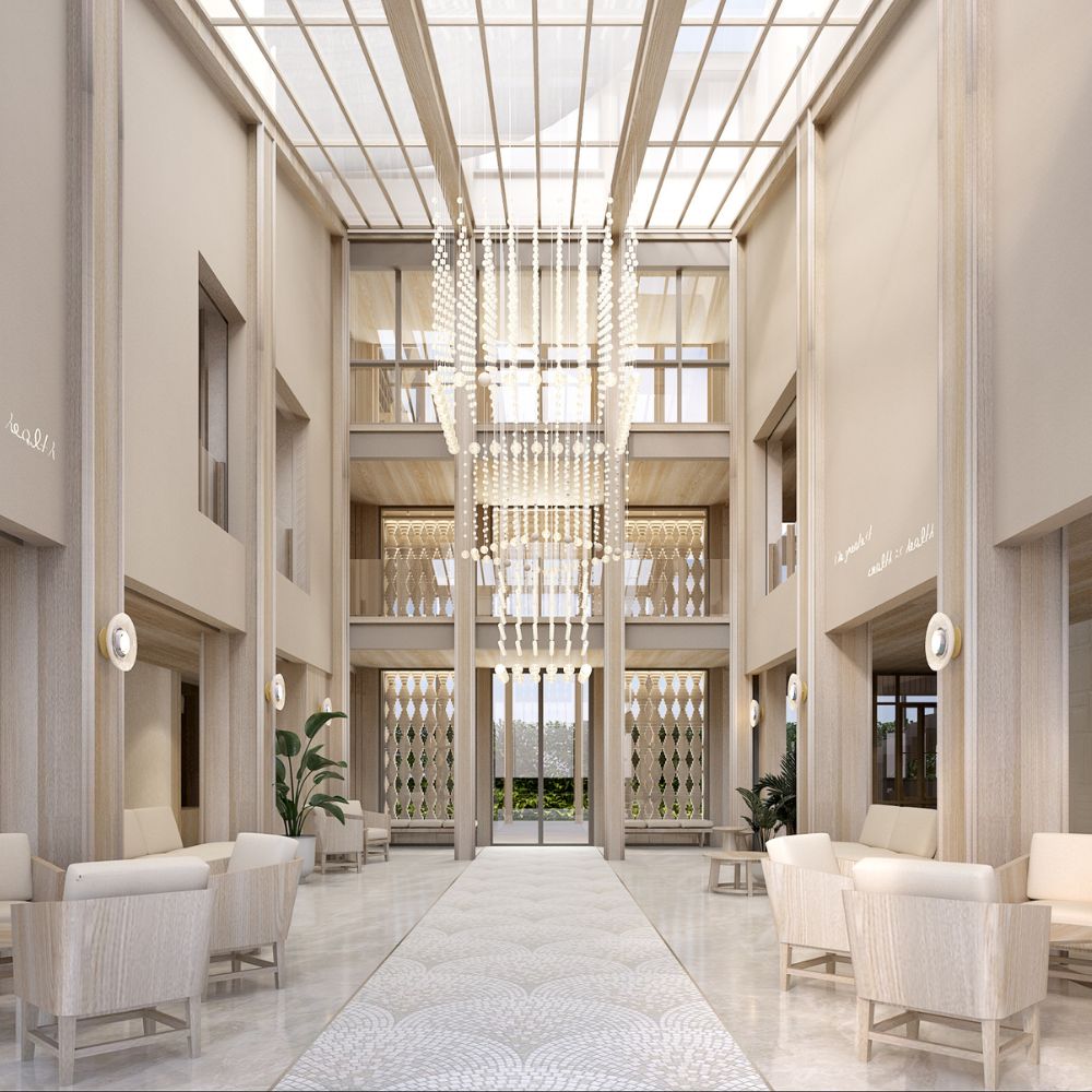 Beachfront wellness resort designed by Openbox Architects featuring a bright open lobby with ocean views, natural light through glass roof, and warm coastal materials.