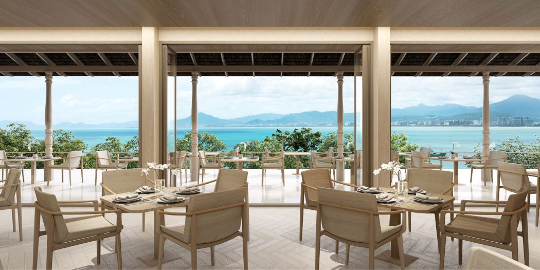 Beachfront wellness resort designed by Openbox Architects featuring a bright open lobby with ocean views, natural light through glass roof, and warm coastal materials.